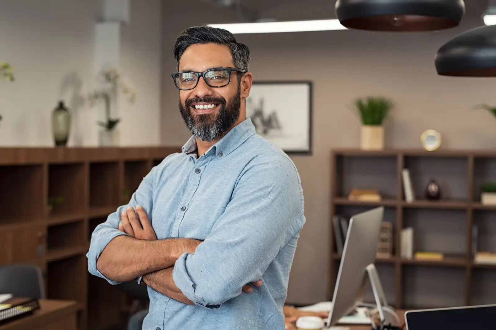 Smiling small business owner standing in his workshop office
